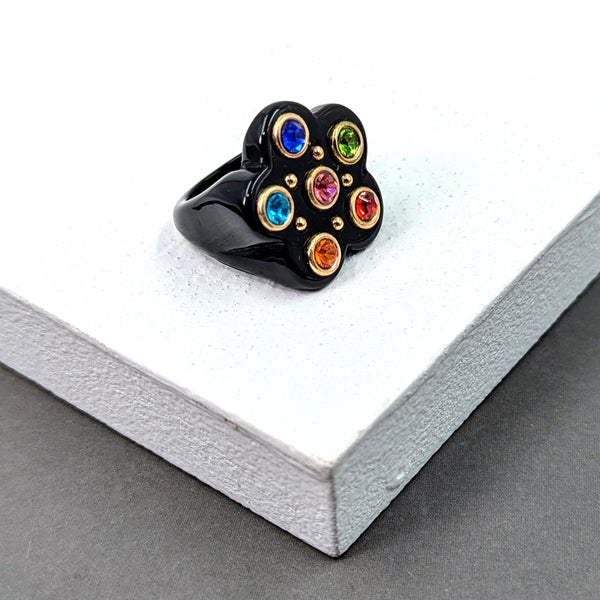 Resin ring with multicoloured inset crystals