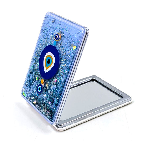 Protective eye compact mirror with iridescent fluid and glitter