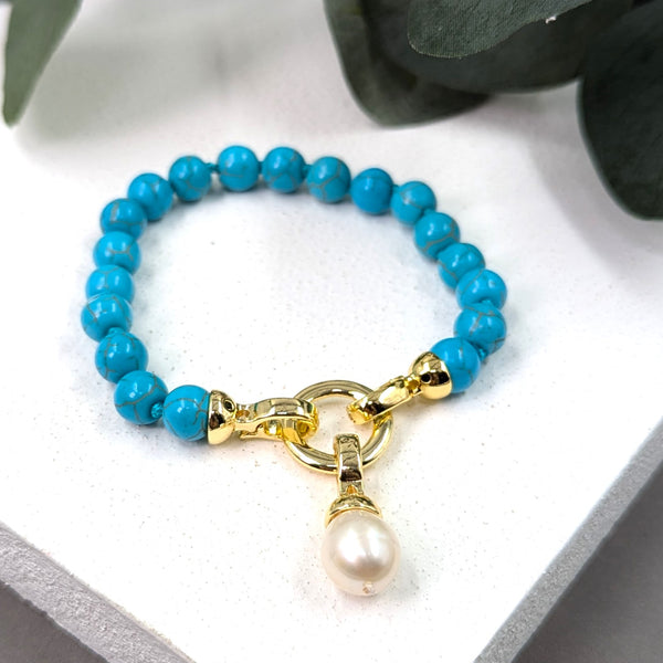 Knotted reconstituted turquoise bracelet with special clasp hanging real pearl charm