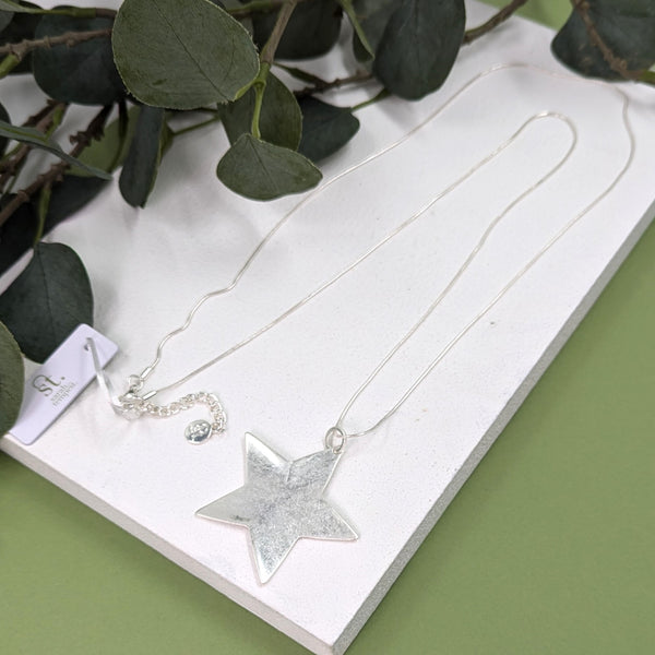 Star pendant on fine snake chain necklace