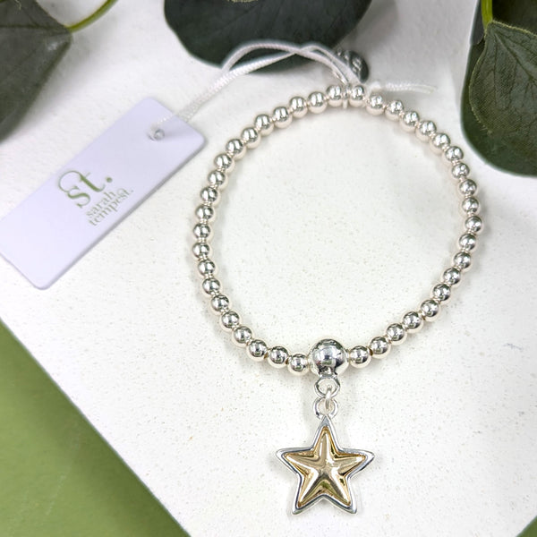 Stretchy beaded bracelet with gold inlay star charm