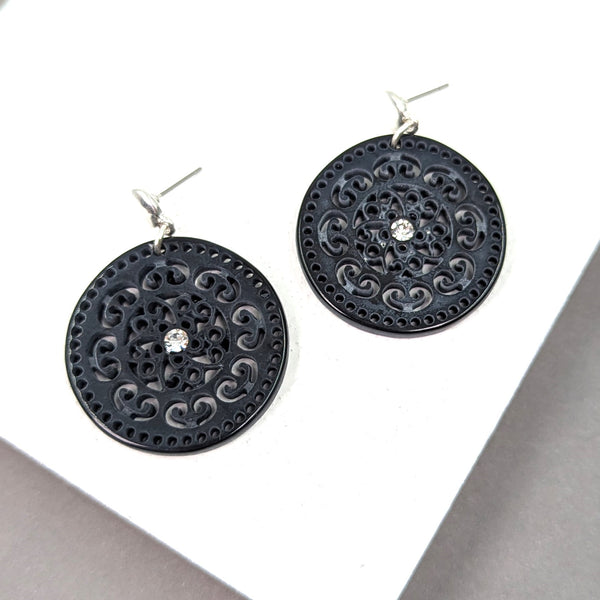 Post earrings w/ a stylish cut out design on resin disc