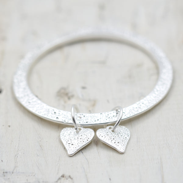 Patterned slim bangle with twin heart drops