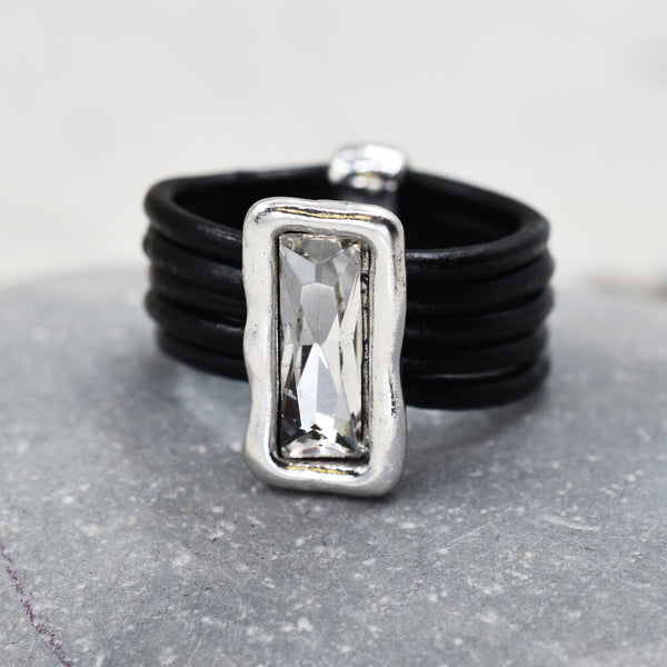 Multi strand black leather ring with central crystal pendant