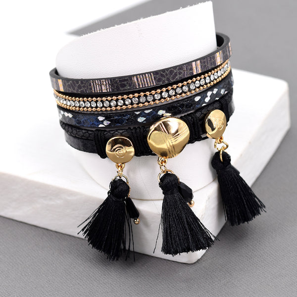 Multi strand cuff with black tassel charms