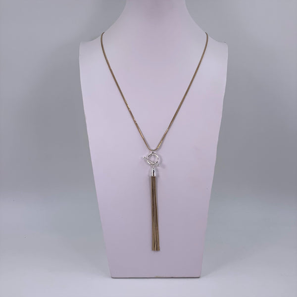 Long silver necklace with tassel pendant