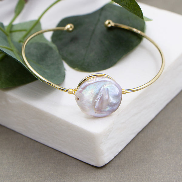 Delicate bangle with real button pearl feature