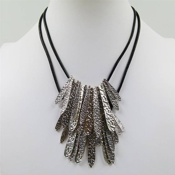 Slim organic pieces on short leather necklace