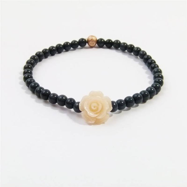 Simple stretchy black bracelet with peach resin flower