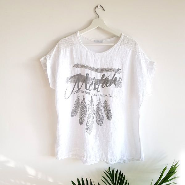 A person who never made a mistake, never tried anything new slogan t-shirt with feather motif