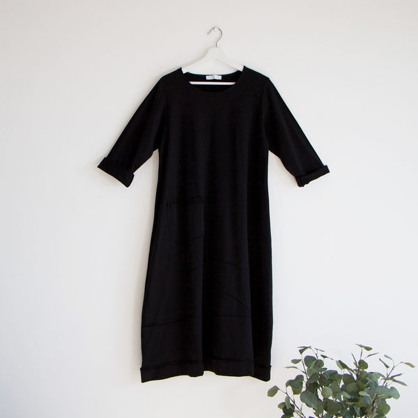 Cotton dress with 3/4 sleeves panel stitching at bottom with pocket detail