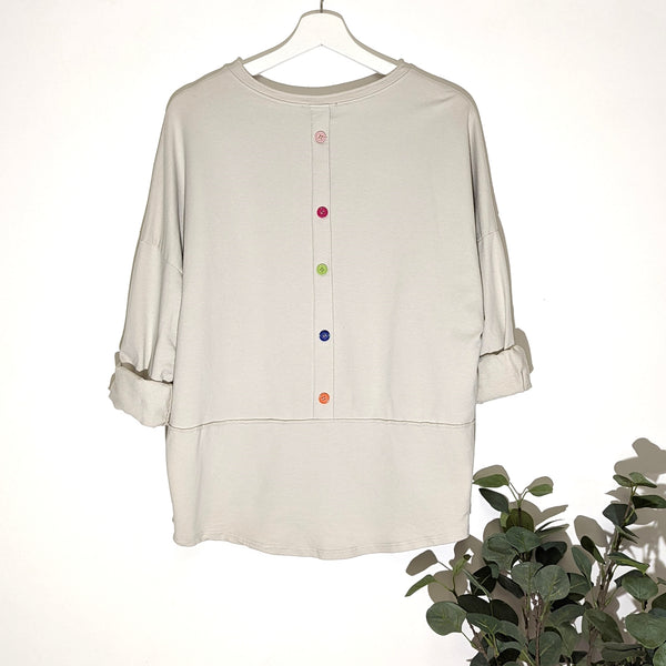 Slight hi-lo jersey top with colour button feature on back (M)