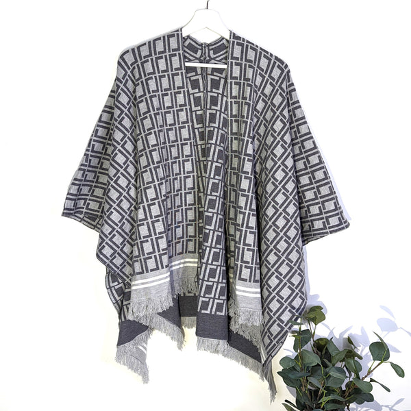 Luxe knit designer style poncho with a subtle fringe