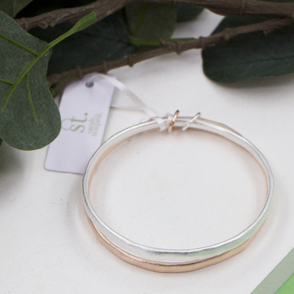 Worn silver and rosegold bangles with links