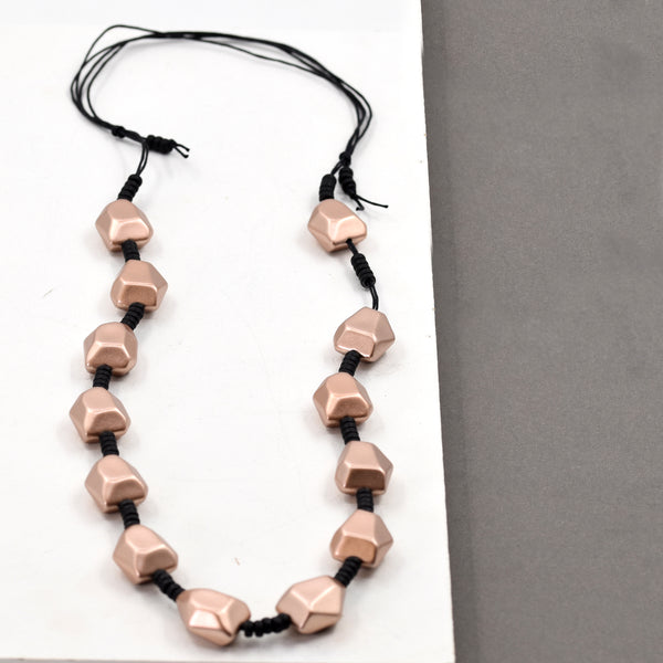 Long necklace with beads and matte rose gold organic shapes