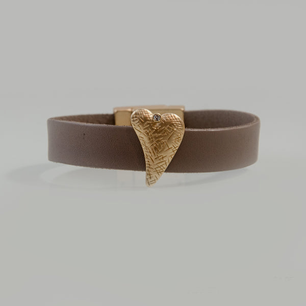 Stylised heart on leather cuff