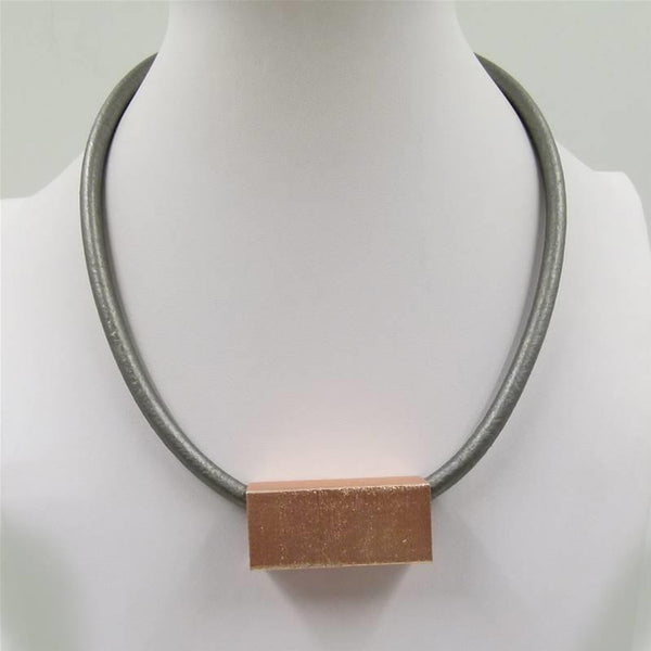 Statement beaten metal feature on short leather necklace