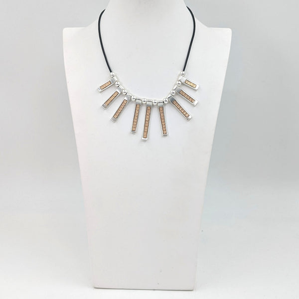 Drops with contrasting metal detail on a short leather necklace