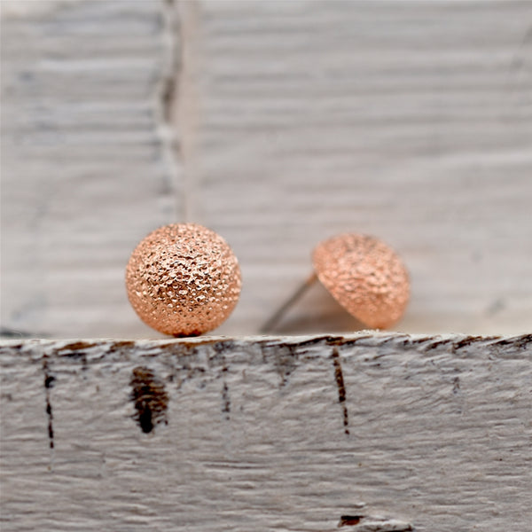 Dappled effect rounded stud earrings