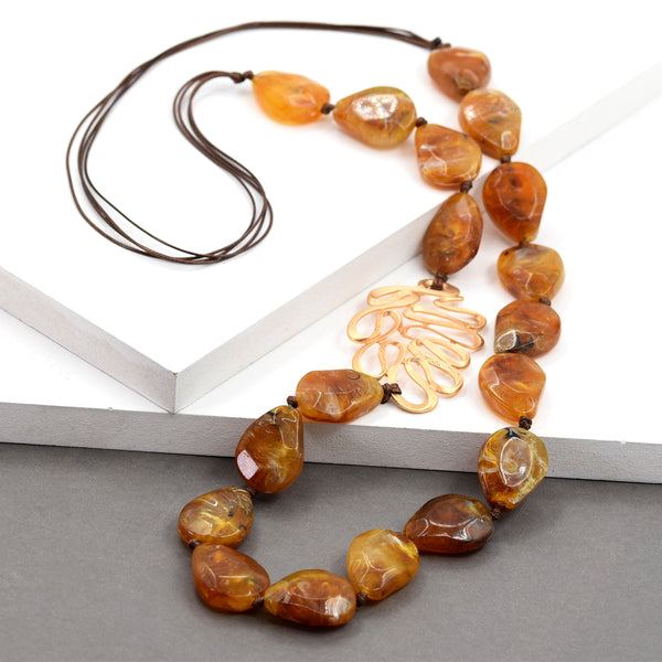 Long pebble necklace with swirly leaf motif necklace